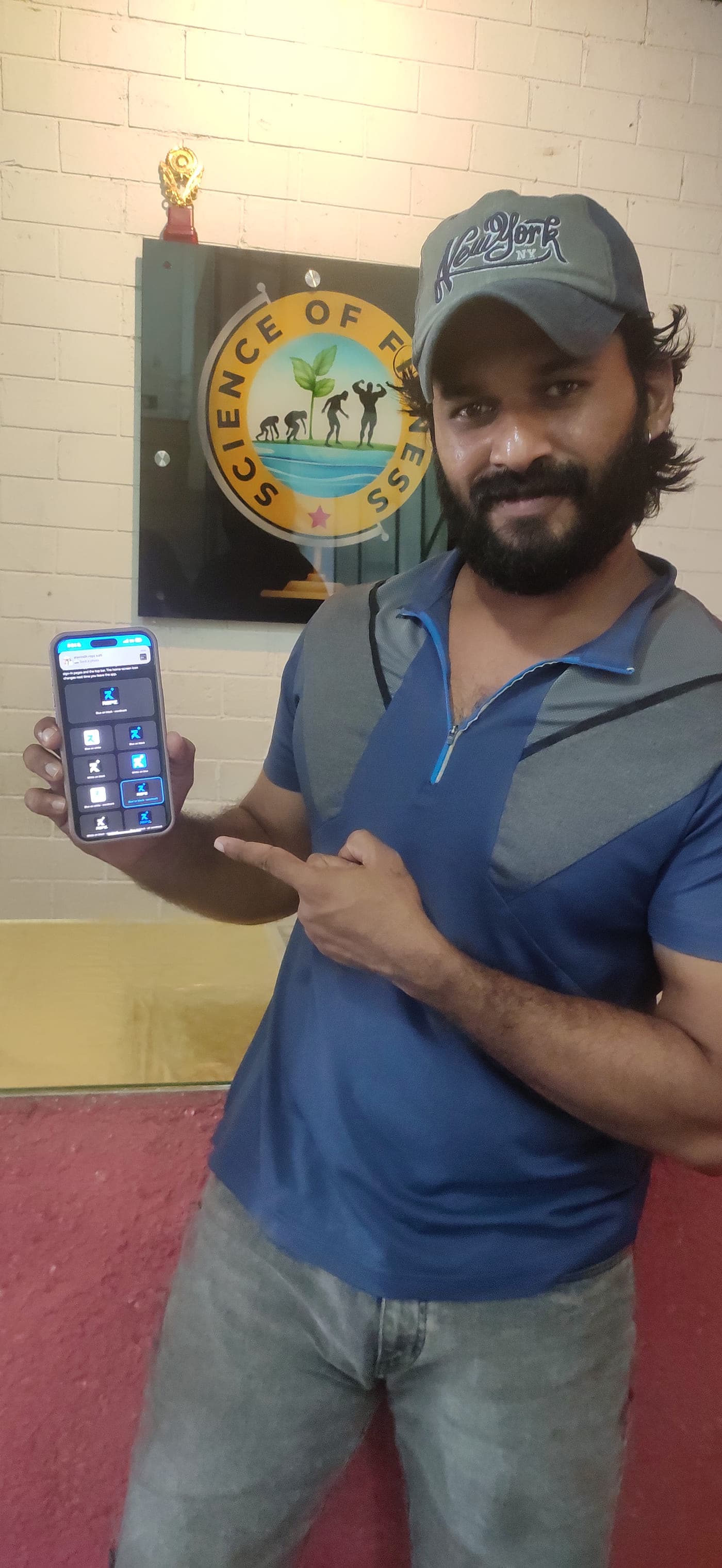 Milton at Science of Fitness, holding his phone with the REPZ app open under the gym's sign.